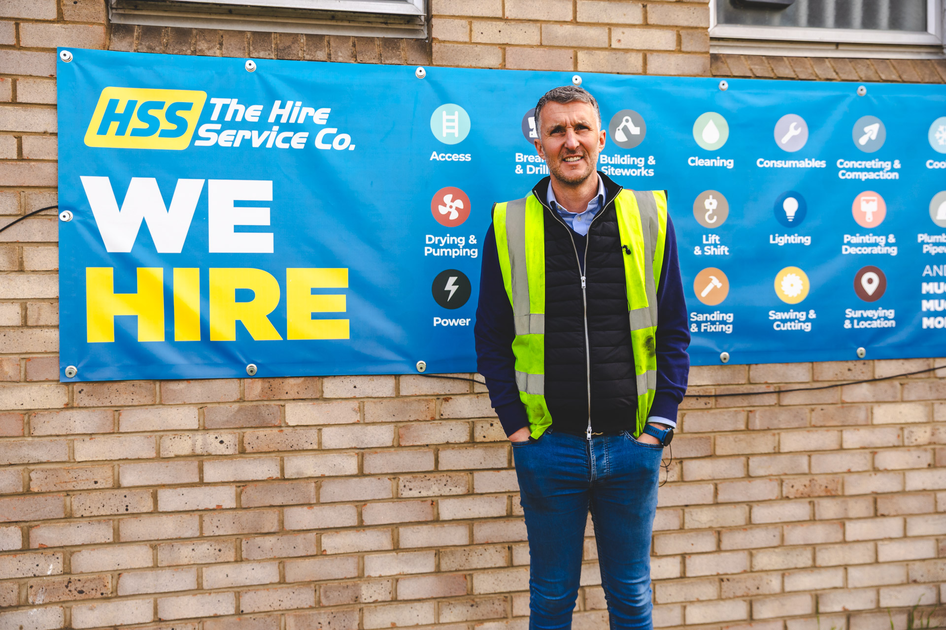 Jon Overman stands in front of a The Hire Service Company branch, reflecting his journey from the shop floor to CEO and his role in leading HSS through business reinvention.