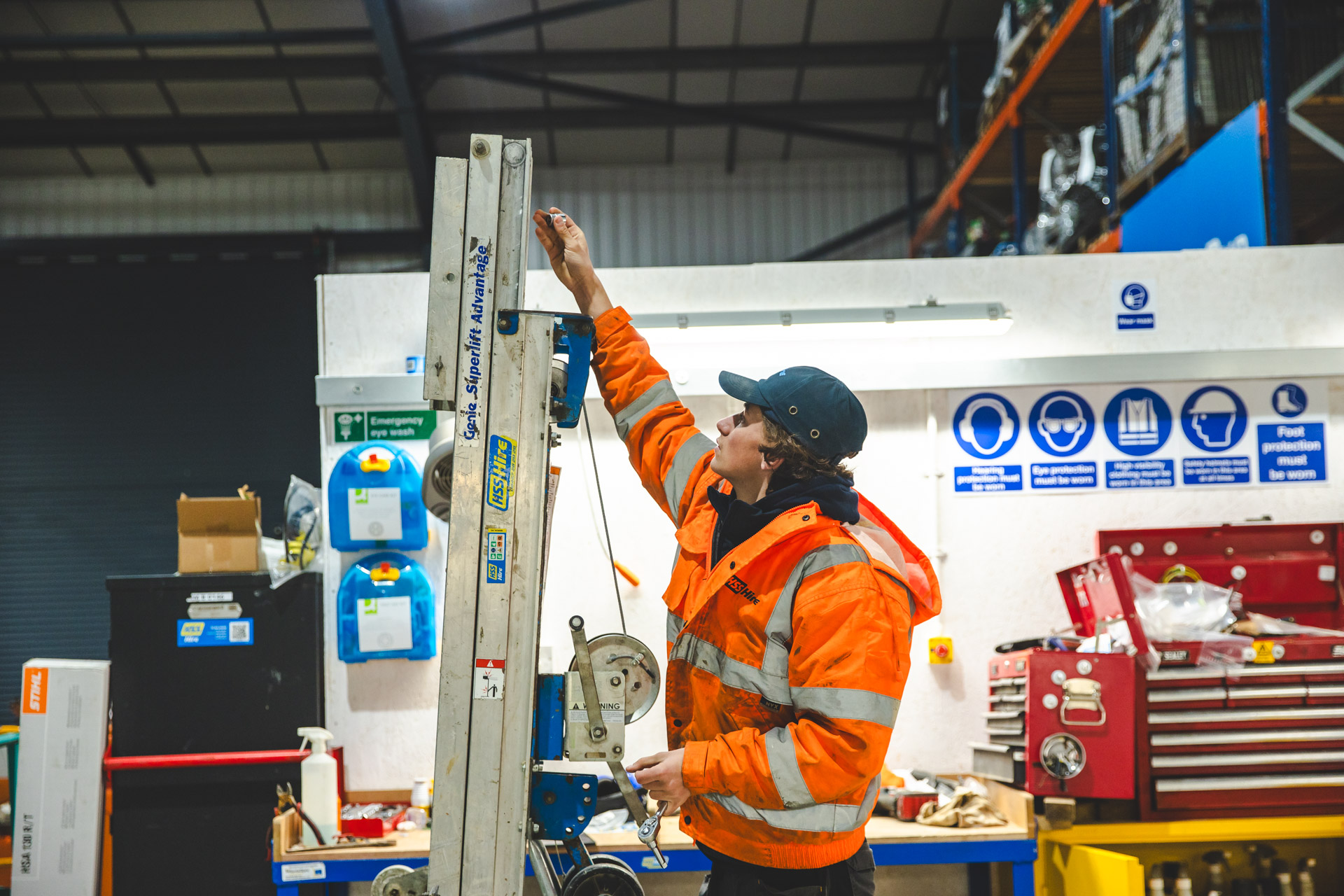 HSS team member working with tool hire equipment in a workshop.